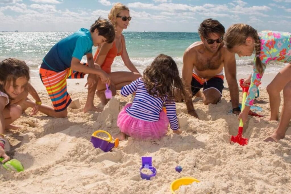 Families and athletes enjoying a friendly beach sports tournament with live music, outdoor activities, and a relaxing coastal atmosphere.