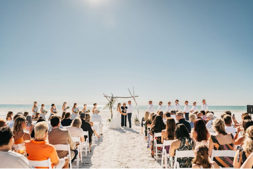 Sophisticated coastal wedding ceremony with glamorous beach wedding dress and ocean views. Beach Dresses
