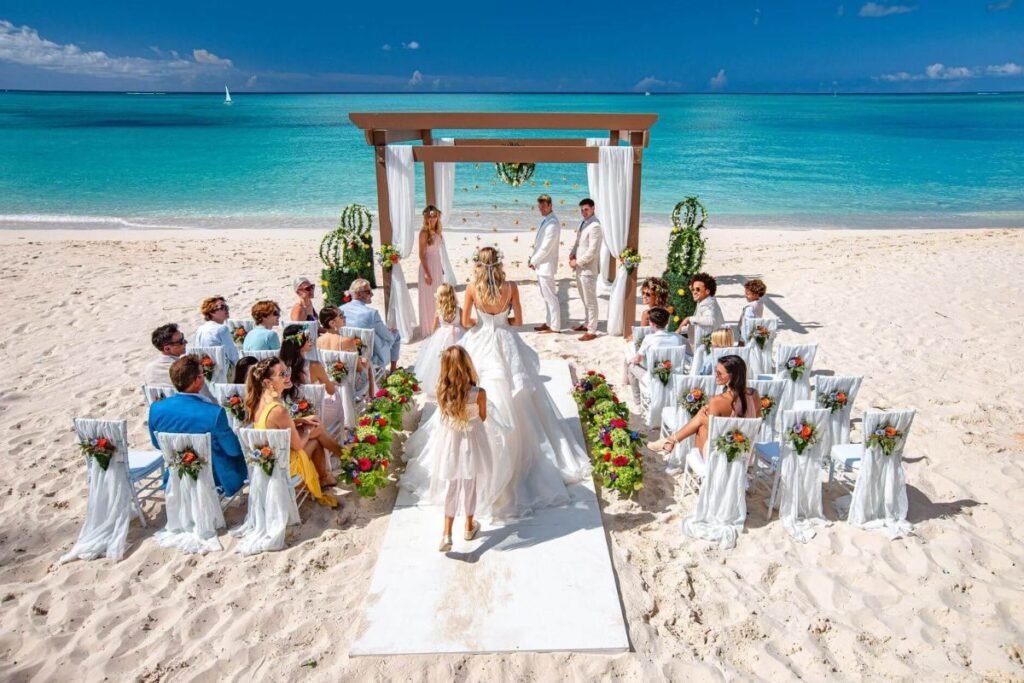 Tropical beach wedding with lightweight sleeveless bridal dress and ocean sunset views. Beach Dresses